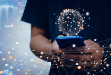 Hand use smartphone global business Internet network connection and social media. Businessman concept holding a global network of futuristic technology background.